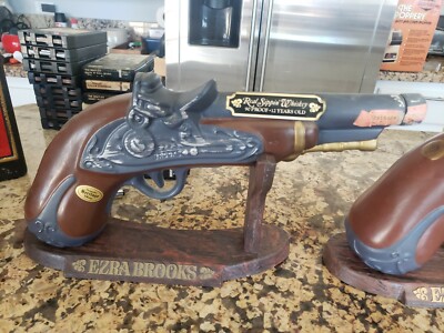 Lot of 2 Red Sippin Whiskey Gun decanter. Ezra Brooks with stand