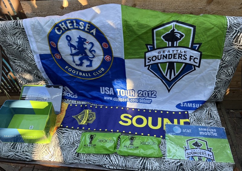 Seattle Sounders FC tin box, scarf, Man U Pennant, Chelsea Flag, MLS Cup Ponchos