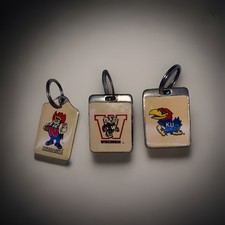 3 vintage keychains with American football team symbols.