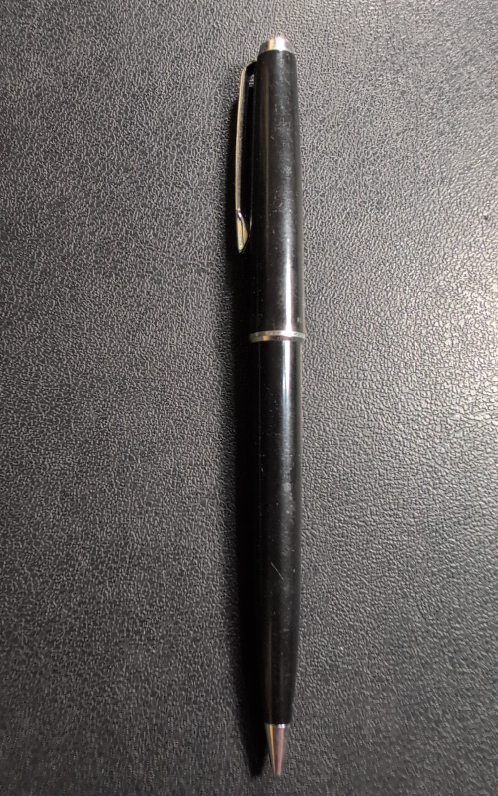 Black Eversharp mechanical pencil with silver tone trim, made in USA, on textured black surface.