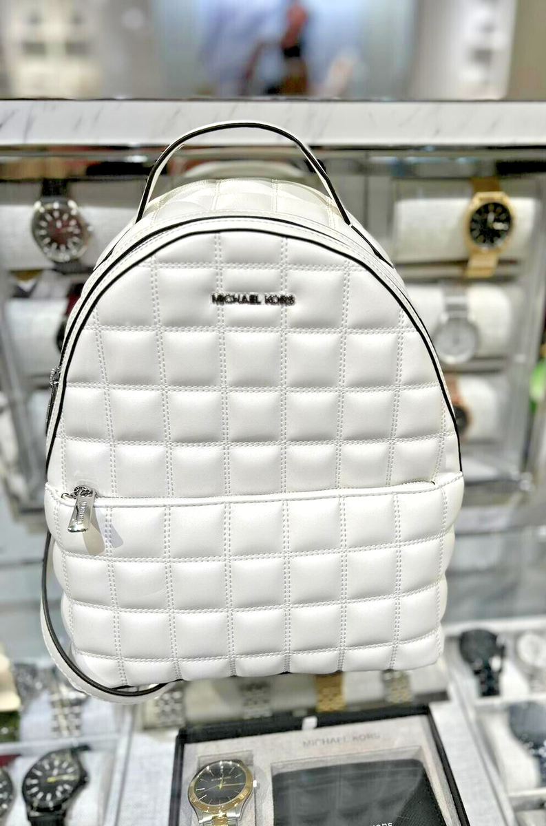Michael Kors Sheila MD Quilted Vegan Leather Front Pocket Backpack (Optic White) Michael Kors Sheila MD Quilted Vegan Leather Front Pocket Backpack (Optic White)
