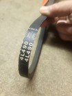 Black Western Auto 46-1949-0 V-belt with white printed specifications and orange side panel, made in USA.