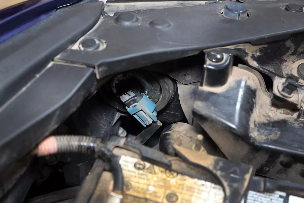 The headlight bulb from the inside of the car, under the hood.