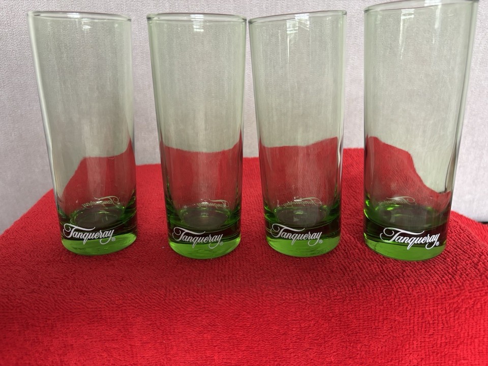 Four vintage Tanqueray-branded emerald-green highball glasses that bring the golden age of gin advertising straight to your home bar.