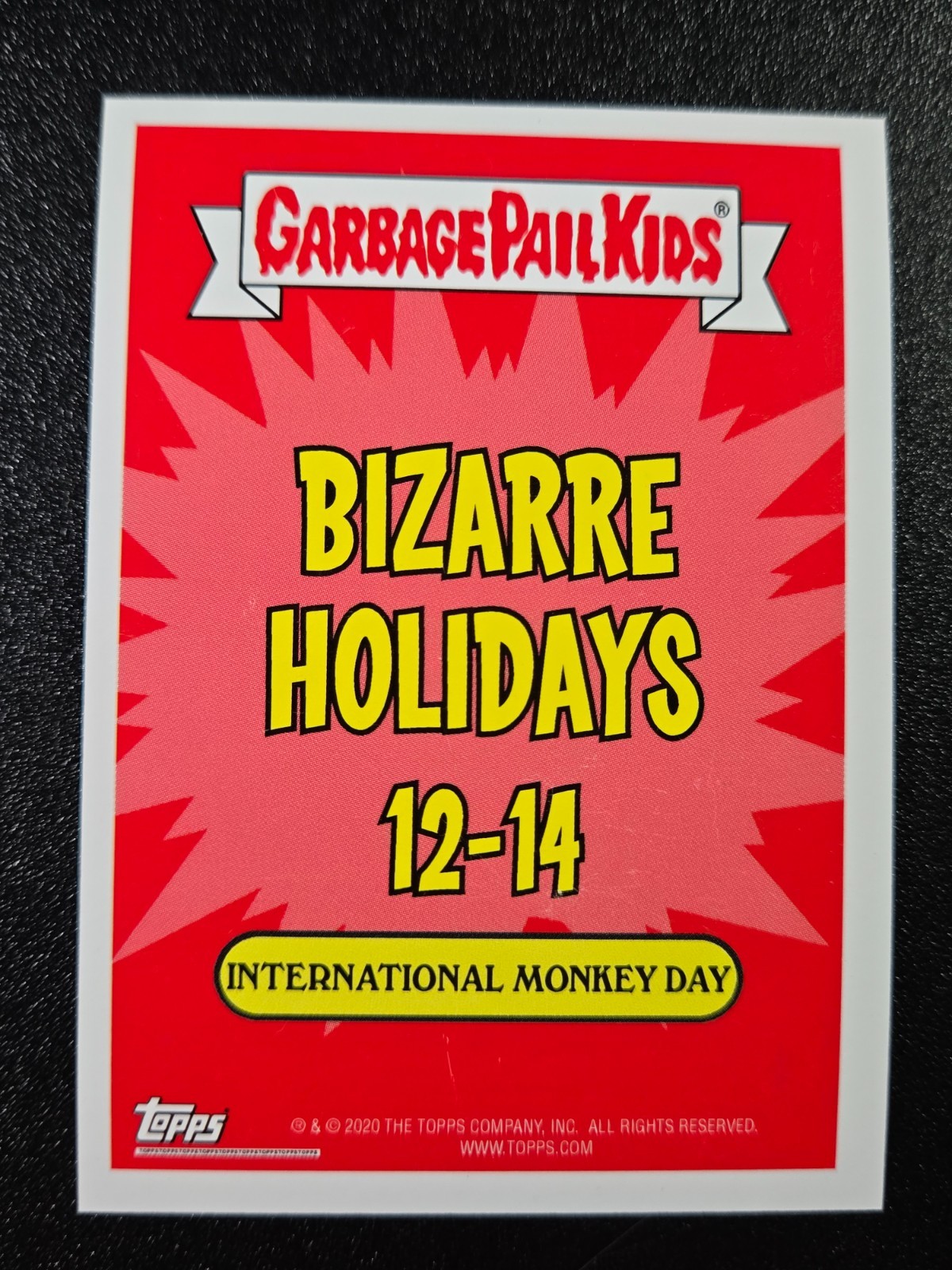 Greaser Greg Chris Hiss Spoof Mechanic Cal Monkey Day Bizarre Holiday card with red and orange cartoon background.