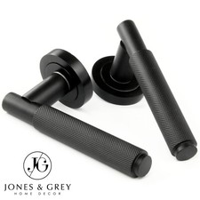 KNURLED DOOR LEVER LATCH HANDLES ON A ROUND ROSE SATIN MATT BLACK CROSS LINED