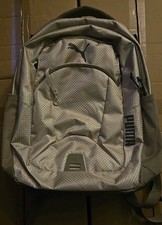 Tan Puma backpack with mesh texture front logo and multiple zipper pockets