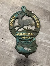 This is a vintage cast iron John Deere letter or match holder from Moline,