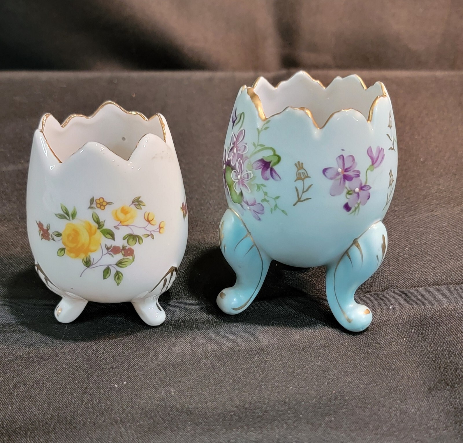 2 Vtg Porcelain 3 Footed Egg Cup Gold Trim Blue w/ Violets, White w/ Roses