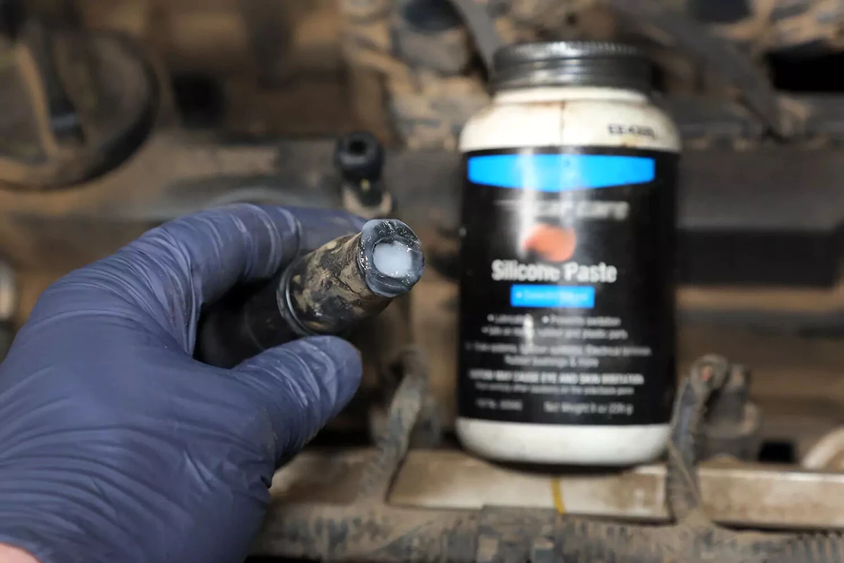 Silicone dielectric grease being applied to an ignition coil boot.