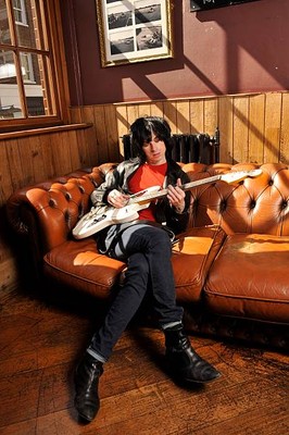 Portrait of musician Barrie Cadogan with his custom electric Phill- Old Photo