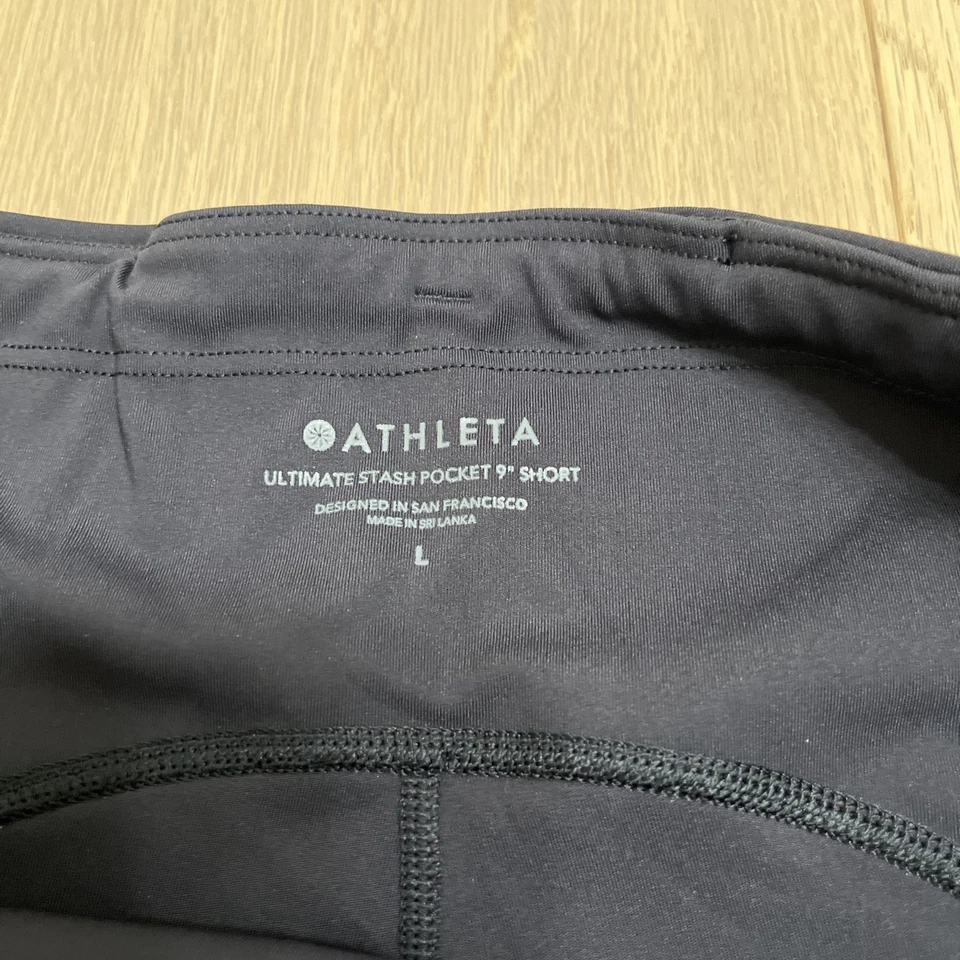 NUEVO CON ETIQUETAS Pantalones Cortos Athleta Ultimate Stash Pocket 9” Negros L Deporte Bicicleta Correr Gimnasio Foto 3 de 4