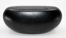 Black hard-shell Prada eyewear case featuring an embossed logo