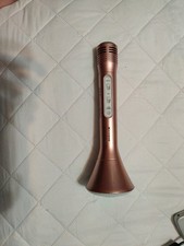 rose gold wireless Bluetooth karaoke microphone and speaker.