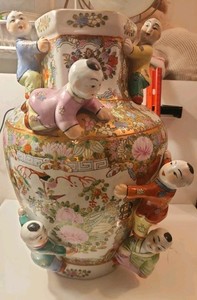 Chinese famille rose porcelain vase with applied figures of children.