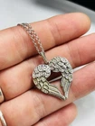 Silver and white stones angel wings pendant with 18 inches chain