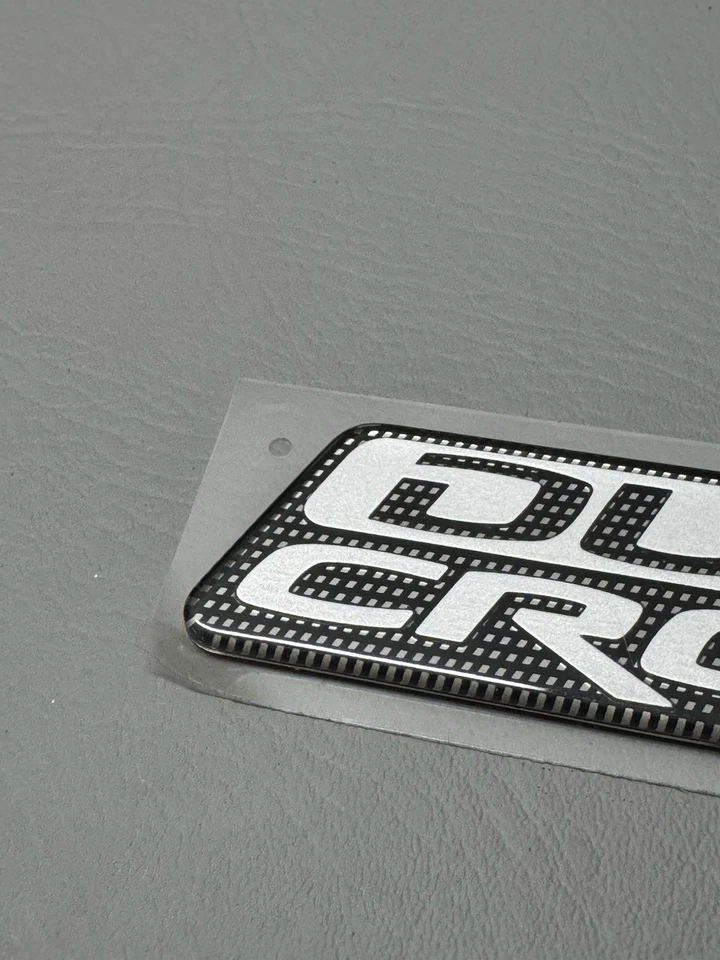 Mitsubishi Raider Duro 2006-2009 emblema de puerta lateral cruzada logotipo insignia usado fabricante original Foto 2 de 4