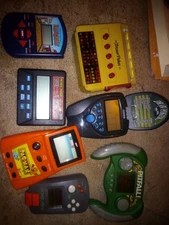 7 HANDHELD GAMES Radica draw poker, Excalibur pitball, MGA Pac-Man & more!