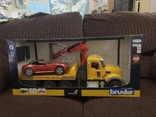 Bruder Man TGS Towtruck with red roadster car