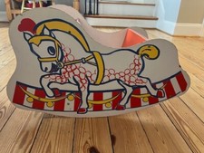 Vintage 1970s metal rocking horse toy. Metal seat. Thin wooden exterior.