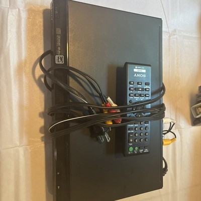 Sony DVP-SR200P DVD player in black, accompanied by a remote control & Cords