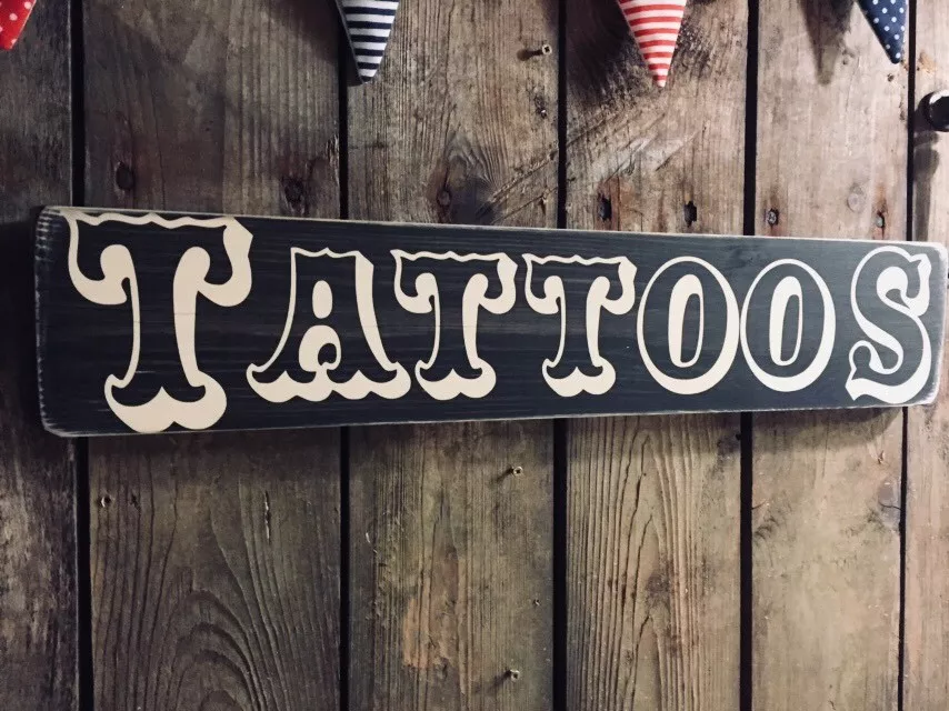Exterior sign at a tattoo studio Stock Photo - Alamy
