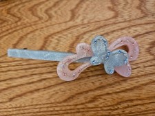 Vintage butterfly hair barrette in blue and pink plastic with rhinestones
