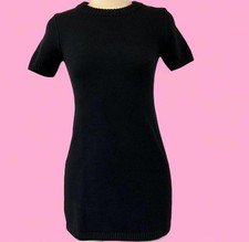 Compact black knit mini dress with short sleeves and a clean crew neckline.