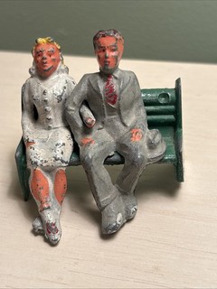 3 Vintage MANOIL Lead Toy Man & Woman On Bench Figurines. Late 1930’s 40’s.