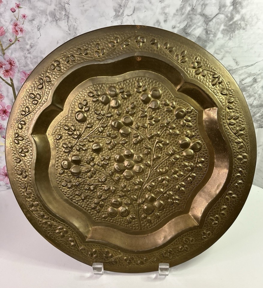 Hand-hammered brass repousse tray that works as both a functional serving piece and striking wall art — dual-purpose MCM charm.