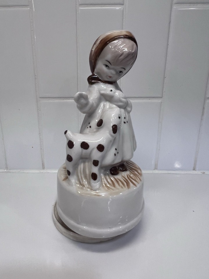 A vintage spinning music box with a girl-and-lamb figurine playing a Burt Bacharach classic — utterly charming and delightfully weird.