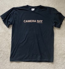 Hubble Studios “Camera Shy” T-Shirt, Black. Sizes Small, Medium, Large