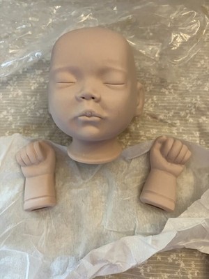 small baby head and hands. Ceramic/bisque. Closed eyes and mouth. 11.25 in circ