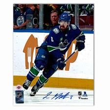 Conor Garland Autographed Vancouver Canucks Home 8x10 Photo (With Puck)