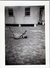 WW2 Photo of Soldier Goofing on Lawn by Wooden Barracks