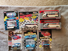 Collection of 7 Vintage Richard Petty Cars & Haulers 1/64 w/original boxes
