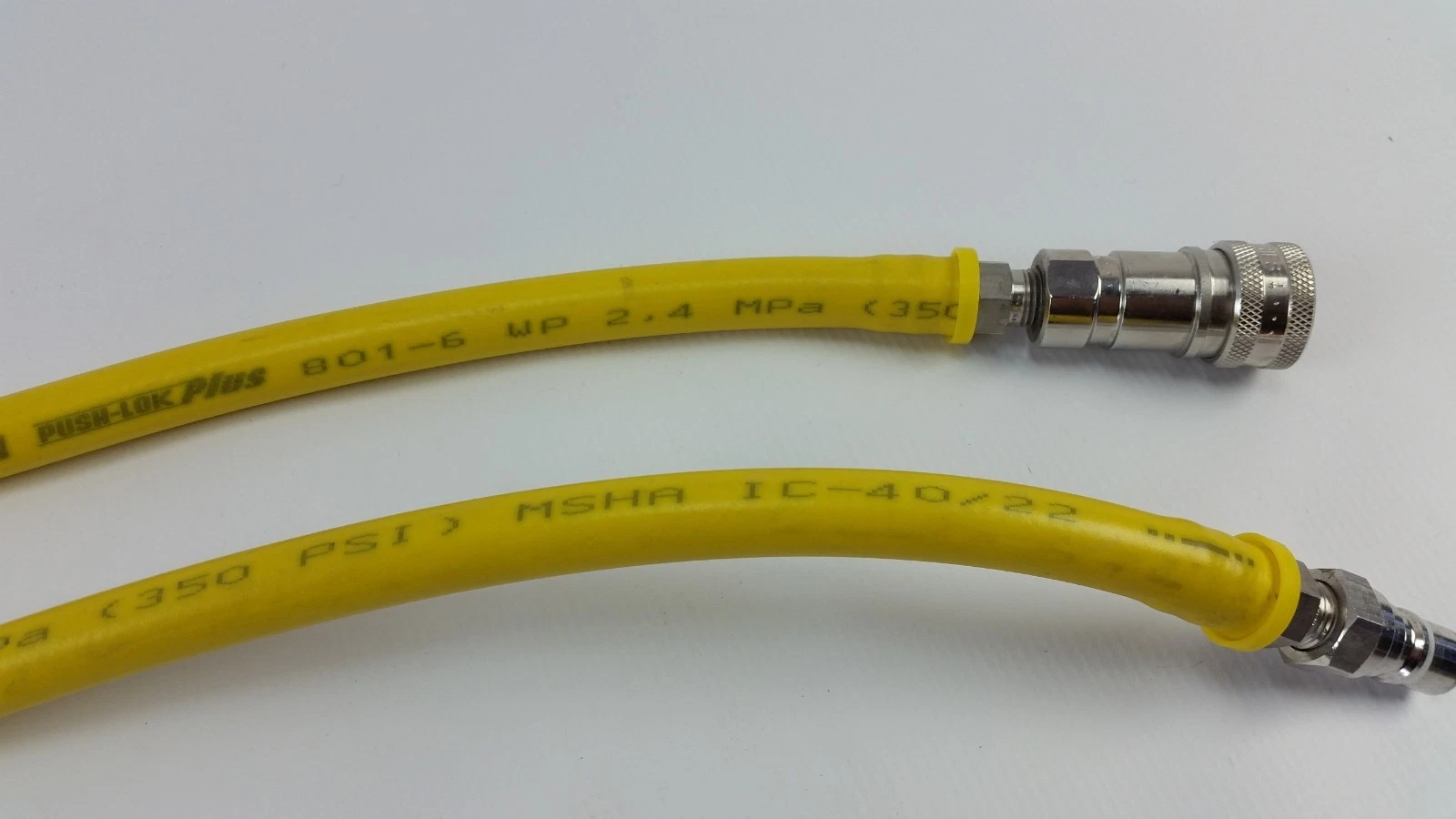 Socket and plug ends beside the Parker Push-Lok Plus hose print
