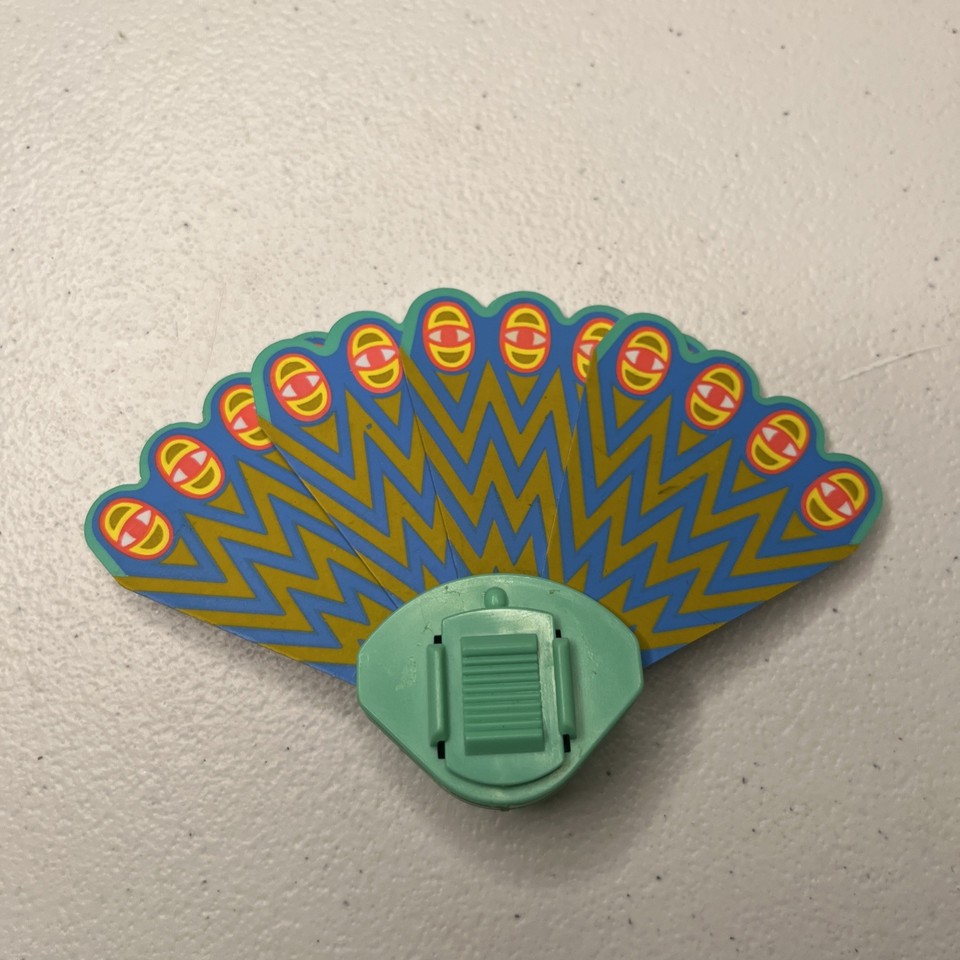 A 1984 She-Ra PEEKABLUE peacock tail backpack accessory in used condition — a hyper-specific vintage toy piece that hits every 80s nostalgia nerve perfectly.