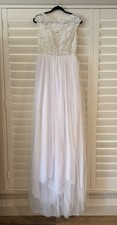 Elegant Ivory and White Wedding Gown with Beaded Bodice Flowing Tulle Skirt