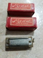 Medal harmonica made in ocupied Japan new in box.