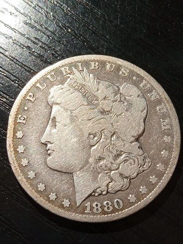 1880-CC Morgan silver dollar. VG. Nice surfaces. No reserve.