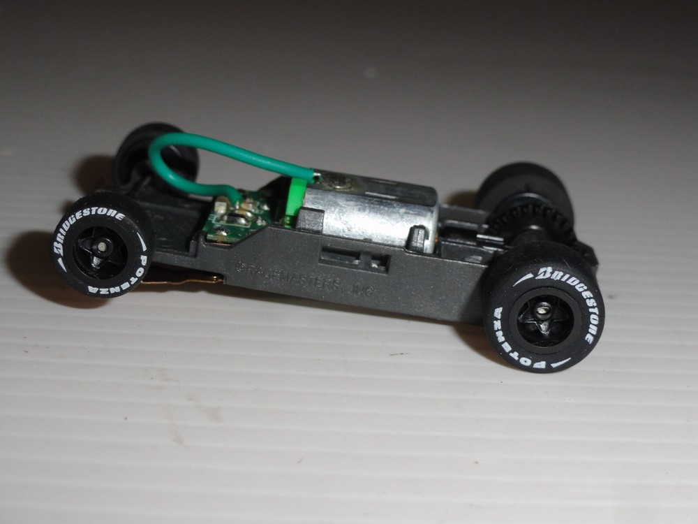 AFX MEGA G+ HO SLOT 1.7 Long Chassis with Black Rims & Bridgestone Tires  