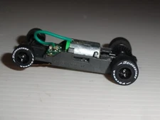 AFX MEGA G+ HO SLOT 1.7 LONG CHASSIS Stock BLACK RIMS AND BRIDGESTONE TIRES
