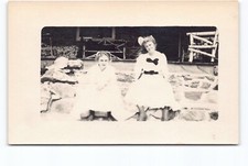 Creepy 2 Girls in White Dresses Bows Sitting Porch Vignette Photo RPPC Postcard