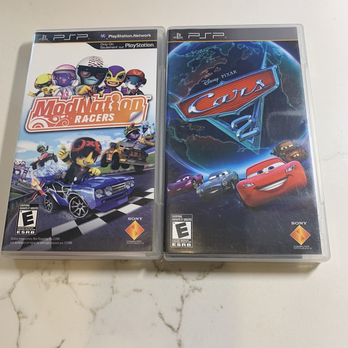2)Games Cars 2 + Mod Nation Racers (PSP) Complete CIB Manual
