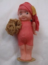 VINTAGE celluloid kewpie doll, in mink papermache dress/hat/w/flower bouquet 3"