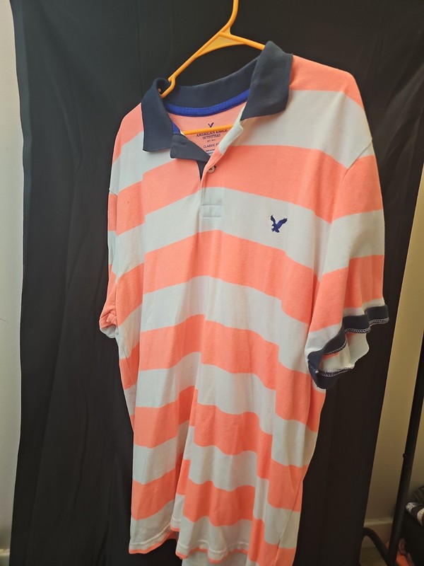 American Eagle Outfitters polo shirt features horizontal Pink and white...