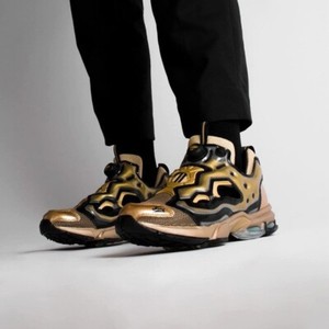 black and gold reebok pumps