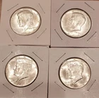 Four 1964 Kennedy half dollars