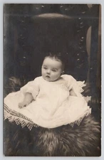 Real Photo Postcard Infant sitting on fur rug c1910 RPPC